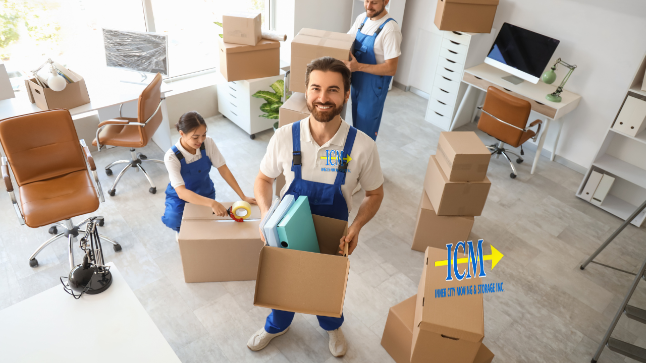 Inner City Moving team carrying branded boxes during an office move