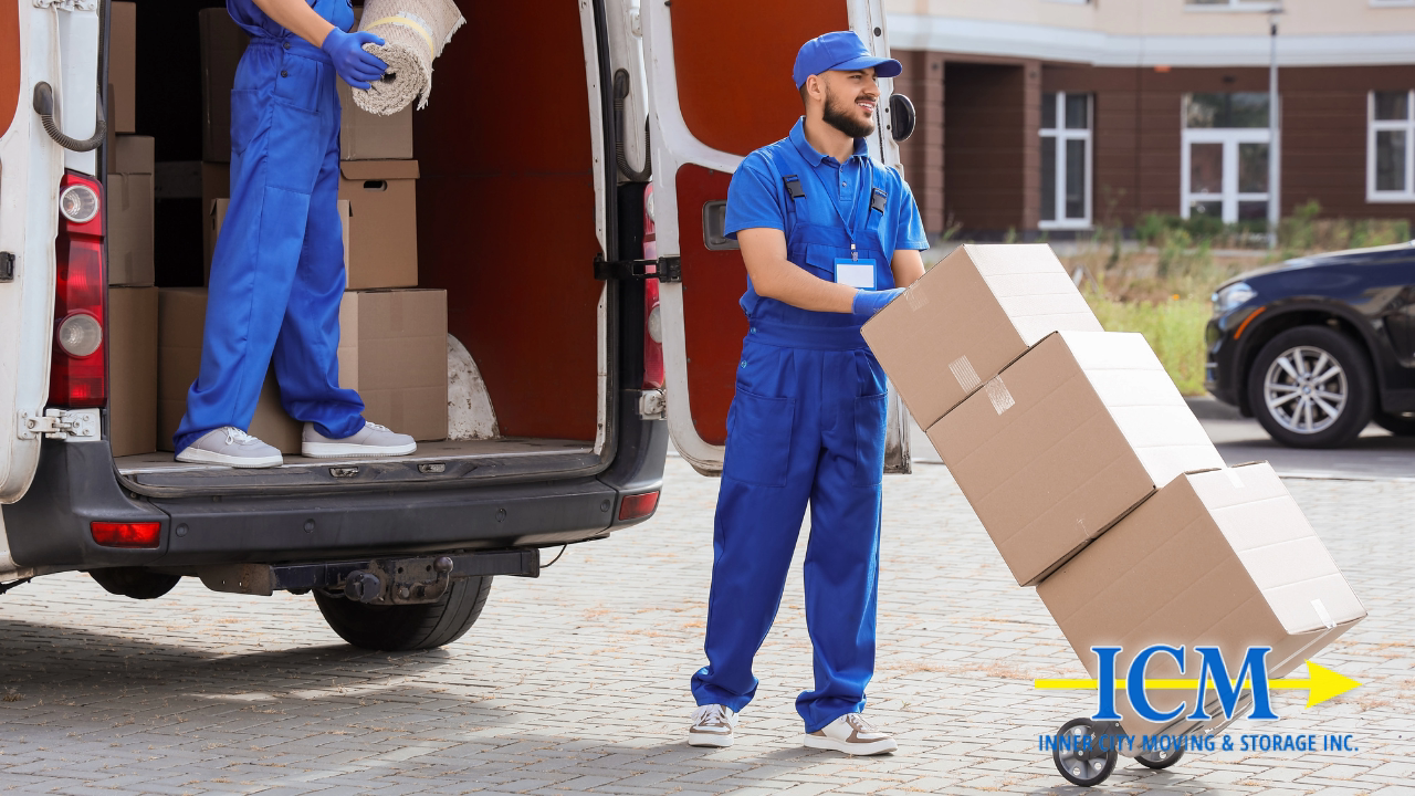 Inner City Moving worker wheeling branded boxes on a dolly