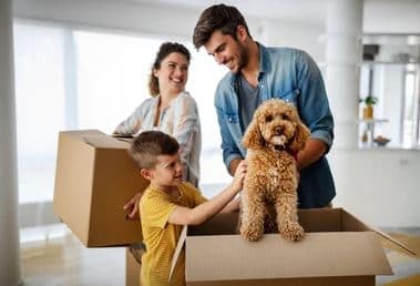 Husband wife and son with pet moving into new home