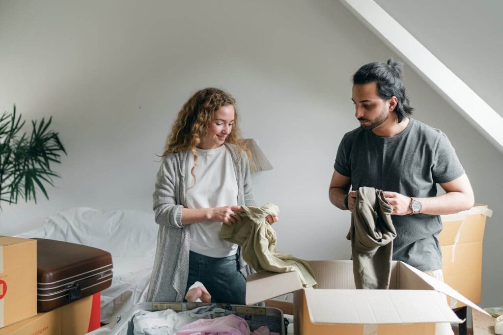 couple unpacking boxes in new apartment