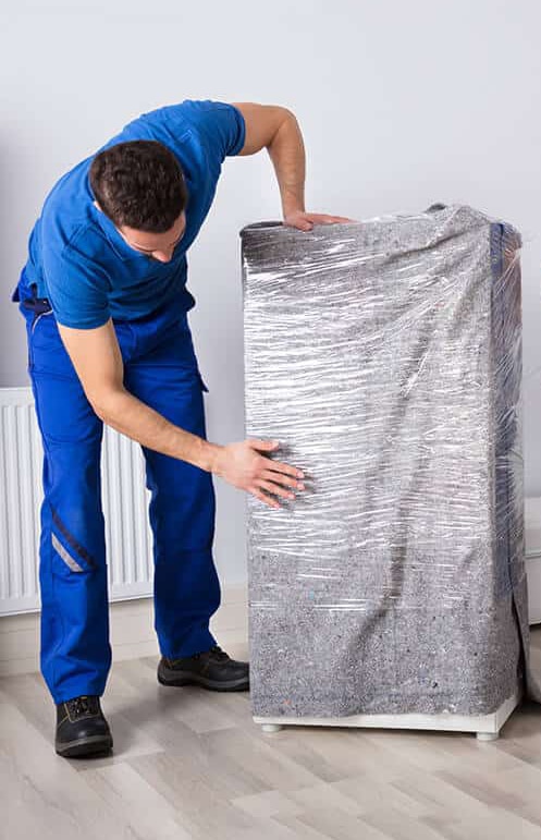Man wrapping the furniture items